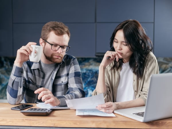 Guy with cup and girl looking at paper