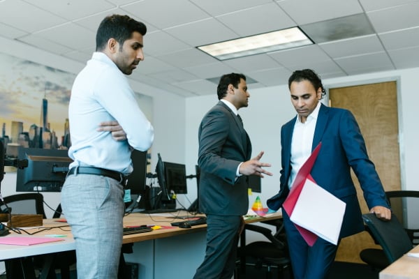 Manager throwing books at colleague